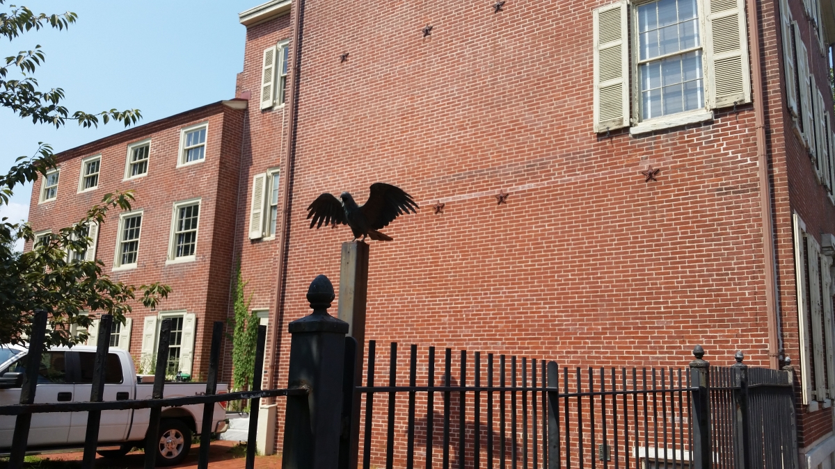 A Sculpture of a Raven next to The Edgar Allan Poe House in Philadelphia