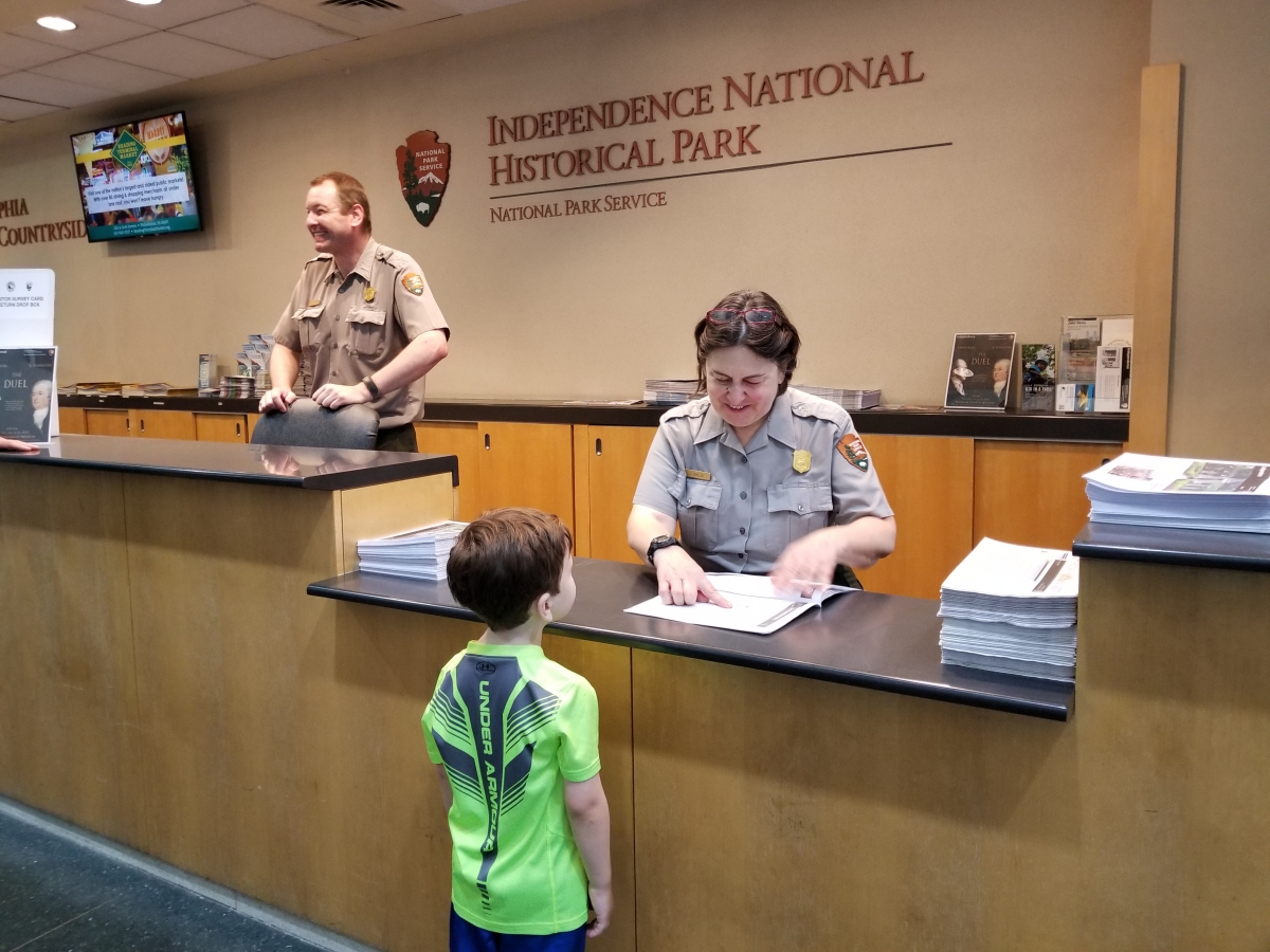 A National Park Ranger Assists a future Junior Ranger A Park Ranger Assists a Future Junior Ranger
